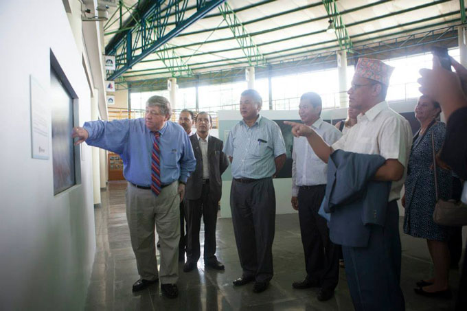 US Ambassador to Nepal, H.E. Peter W. Podde exploring the interactive Microsoft touch screen that is loaded with several interactive flights over the Khumbu region produced by GlacierWorks. Photo: Shikhar Bhattarai