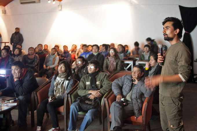 Kathmandu International Art Festival (KIAF)'s Nischal Oli showing some of the photo works exhibited at the festival.Photo: Shikhar Bhattarai