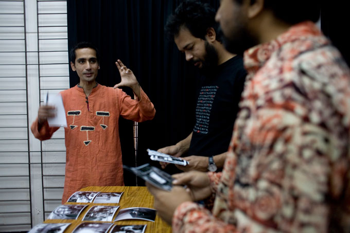 Sailendra Kharel (left) editing pictures with Munem Wasif & Abir Abdullah.